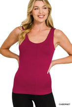 A fitted solid magenta zenana seamless tank top with built in bra featuring a rounded neckline and sleeveless design