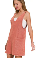 Coral-colored zenana washed adjustable strap denim overall dress in soft coral pink with front pockets and white inner top