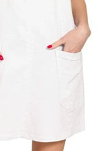 White cotton dress with simple clean design and side pockets featuring washed adjustable strap denim overall dress style