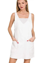 White sleeveless dress with square neckline and front pockets featuring a washed adjustable strap design