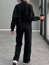 Black oversized zip-up sweatshirt with dropped shoulders and ribbed cuffs