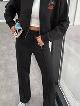 Black sweatpants with side zipper pockets and red logo from Zip Up set