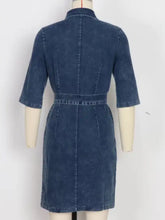 Denim dress with fitted silhouette, three-quarter sleeves, and belted waist in short sleeve denim style