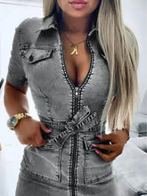 A fitted short sleeve denim dress in faded gray wash with front zipper and belt tie detail