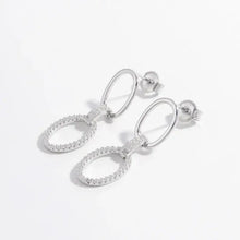 Pair of sterling silver dangle earrings with oval CZ accents